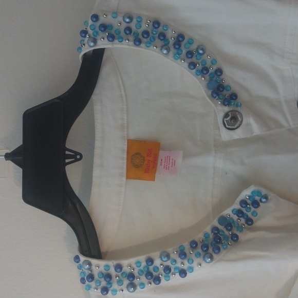 White jean jacket adorned with blue rhinestone like pieces. - Picture 3 of 6